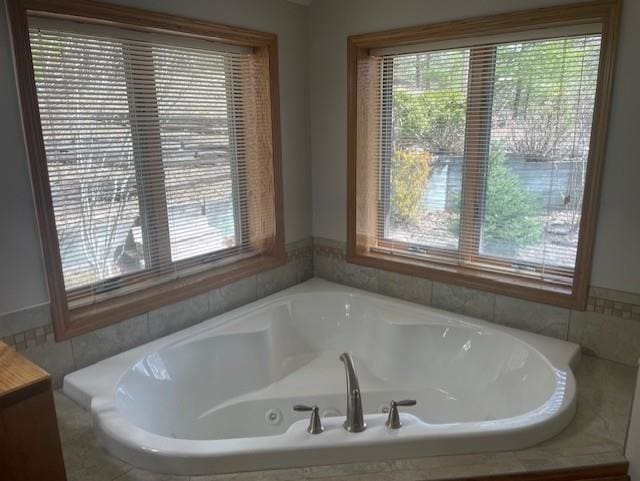 full bathroom with a bath and a healthy amount of sunlight