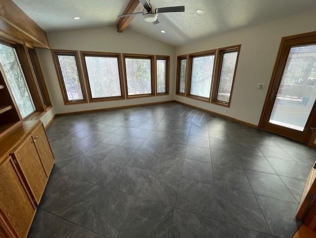 interior space with baseboards, a ceiling fan, vaulted ceiling with beams, and recessed lighting