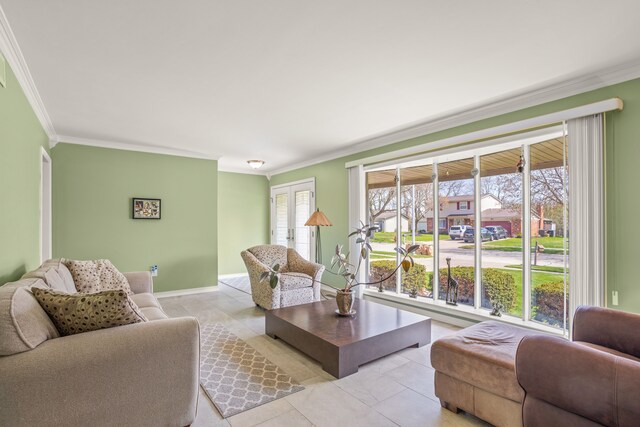 living room featuring crown molding, light tile patterned floors, and baseboards