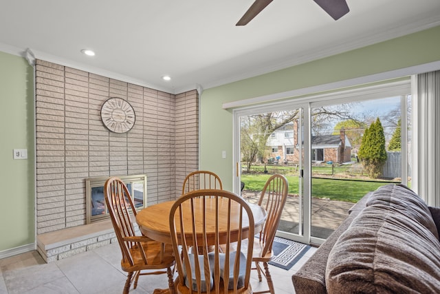 dining area featuring ornamental molding, a ceiling fan, recessed lighting, and a brick fireplace
