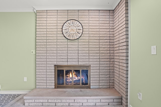 details featuring a brick fireplace, baseboards, and ornamental molding