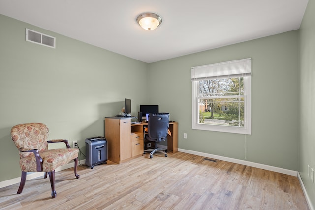 home office with baseboards, visible vents, and light wood-style floors