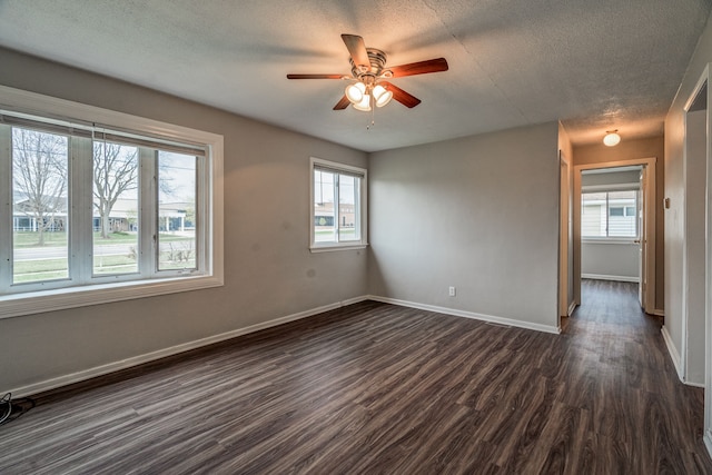 34038 Caseville Ct, Westland, MI 48186 - unfurnished room with dark wood finished floors, a textured ceiling, a ceiling fan, and baseboards