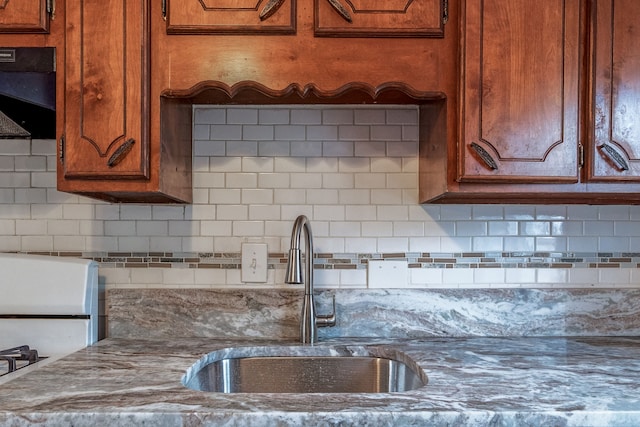 34038 Caseville Ct, Westland, MI 48186 - kitchen featuring range, a sink, brown cabinets, and tasteful backsplash