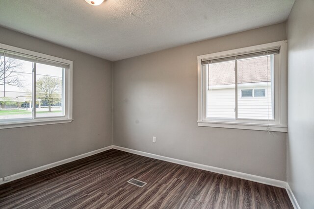 34038 Caseville Ct, Westland, MI 48186 - spare room with dark wood-style flooring, a healthy amount of sunlight, and baseboards