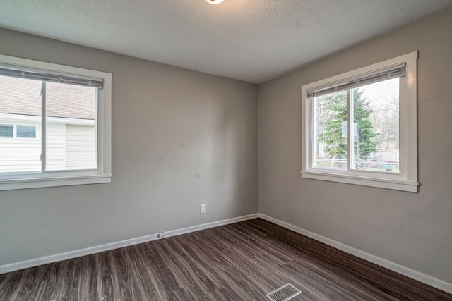 34038 Caseville Ct, Westland, MI 48186 - unfurnished room featuring baseboards, visible vents, a textured ceiling, and dark wood-style floors