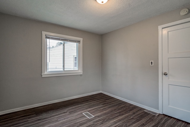 34038 Caseville Ct, Westland, MI 48186 - unfurnished room featuring baseboards, visible vents, a textured ceiling, and dark wood-style floors