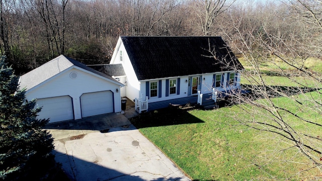 cape cod home with an outdoor structure, roof with shingles, a front yard, and driveway