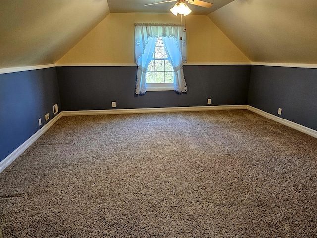 additional living space featuring carpet floors, a ceiling fan, and lofted ceiling