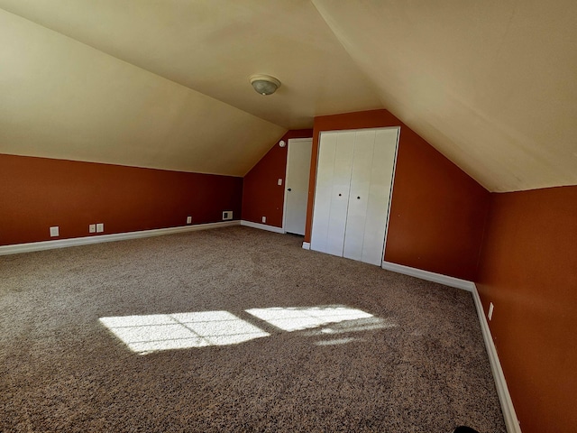 bonus room featuring baseboards, vaulted ceiling, and carpet flooring