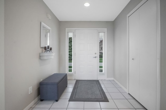 entryway featuring recessed lighting, baseboards, and light tile patterned floors