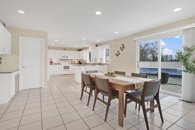 dining room with light tile patterned floors and recessed lighting