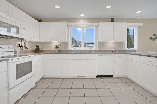 kitchen with recessed lighting, white appliances, a sink, and white cabinetry