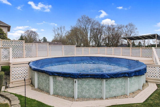 view of pool featuring a fenced in pool and a deck