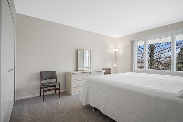 bedroom featuring light carpet and baseboards