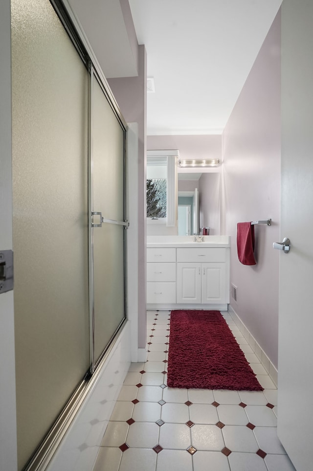 full bathroom with vanity, visible vents, and combined bath / shower with glass door