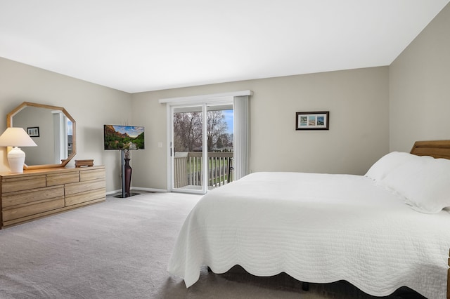 carpeted bedroom with baseboards and access to outside