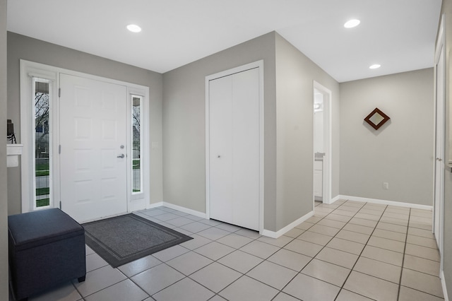 entrance foyer with baseboards, light tile patterned flooring, and recessed lighting