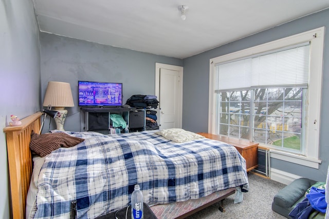 carpeted bedroom featuring baseboards