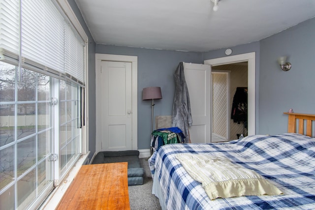 bedroom with baseboards and carpet