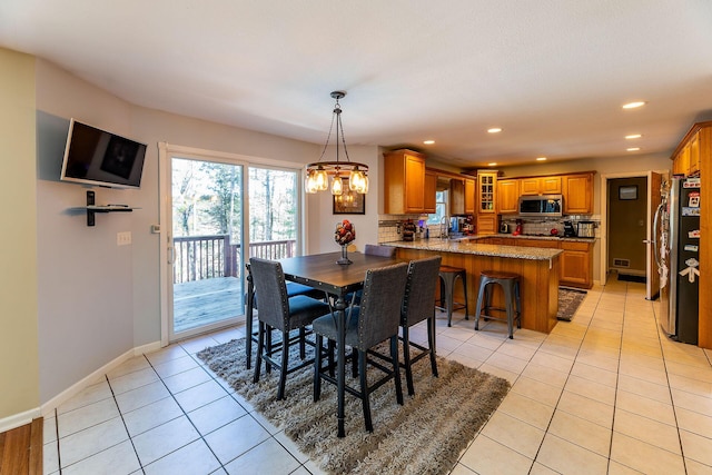 dining space with visible vents, baseboards, recessed lighting, a chandelier, and light tile patterned floors