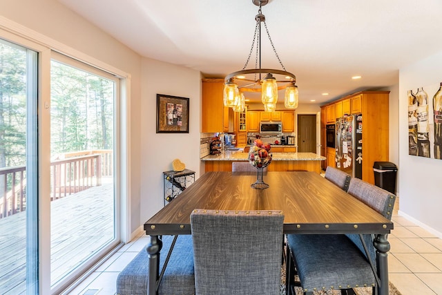 dining space with recessed lighting, baseboards, and light tile patterned floors
