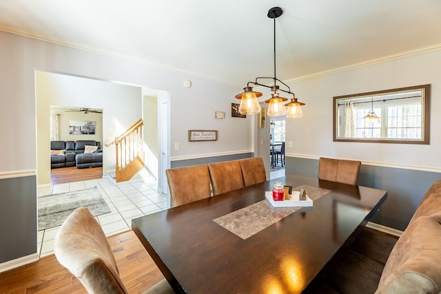 dining space with stairway, baseboards, ornamental molding, and wood finished floors