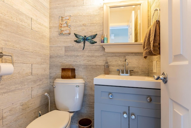 half bathroom featuring vanity and toilet