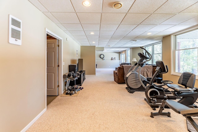exercise area with baseboards, carpet flooring, visible vents, and a paneled ceiling