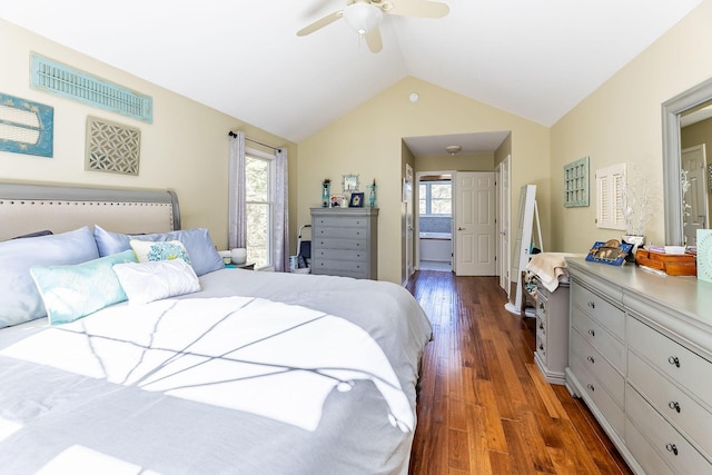 bedroom featuring vaulted ceiling, ensuite bath, ceiling fan, and wood finished floors