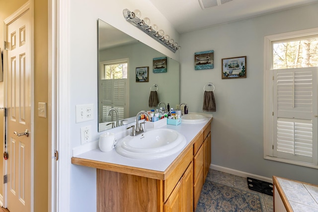 bathroom featuring a wealth of natural light, a sink, and double vanity