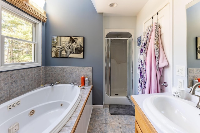 full bath with vanity, tile patterned flooring, a shower stall, and a tub with jets