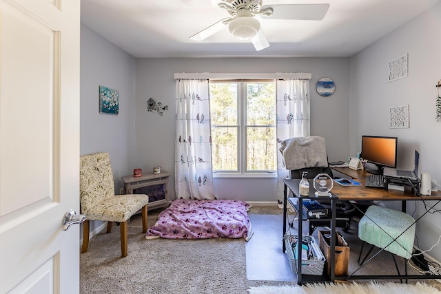 home office with a ceiling fan, baseboards, and carpet floors