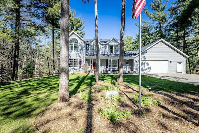 view of front facade with an attached garage, driveway, covered porch, and a front yard