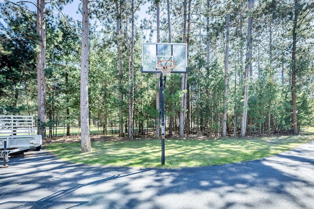 view of basketball court with a forest view and basketball court