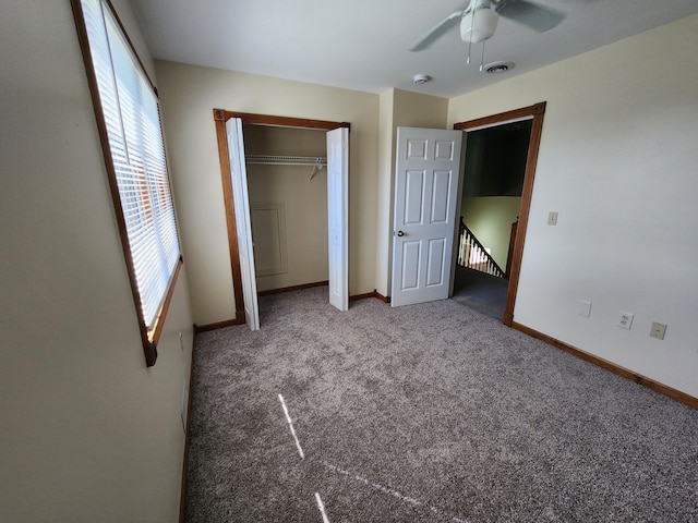 unfurnished bedroom featuring carpet, visible vents, a closet, baseboards, and ceiling fan