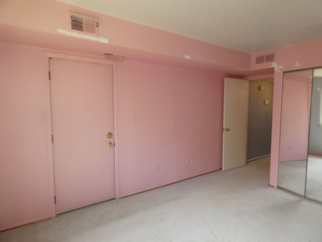 unfurnished bedroom with carpet flooring and visible vents