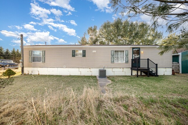 10269 30th Ave, Evart, MI 49631 - view of front of house featuring a front lawn and central AC unit