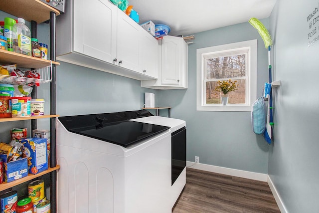 laundry room featuring washing machine and dryer, dark wood-style flooring, baseboards, and cabinet space