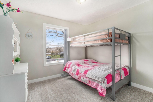 bedroom featuring carpet and baseboards