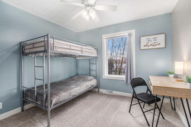 bedroom featuring baseboards, a ceiling fan, visible vents, and carpet
