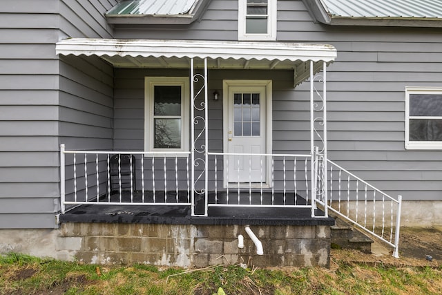 doorway to property featuring metal roof