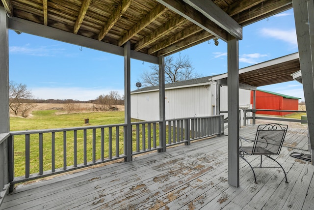wooden terrace with a lawn