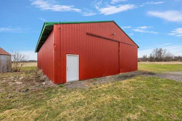 view of pole building with a lawn