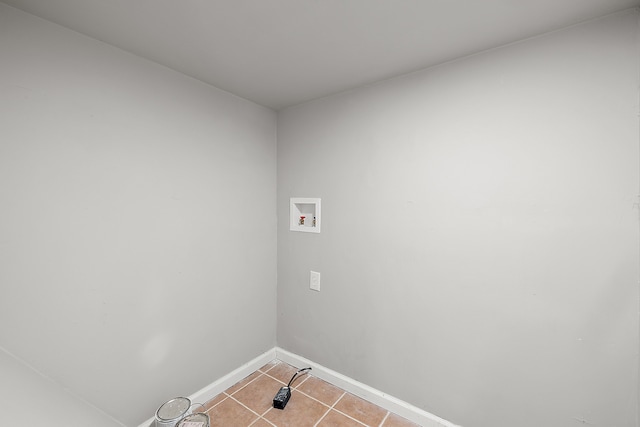 washroom featuring light tile patterned flooring, hookup for a washing machine, baseboards, and laundry area