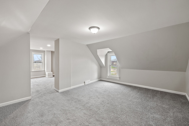 bonus room with vaulted ceiling, visible vents, baseboards, and carpet