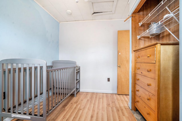 bedroom featuring baseboards and wood finished floors