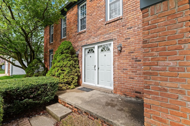 entrance to property with brick siding