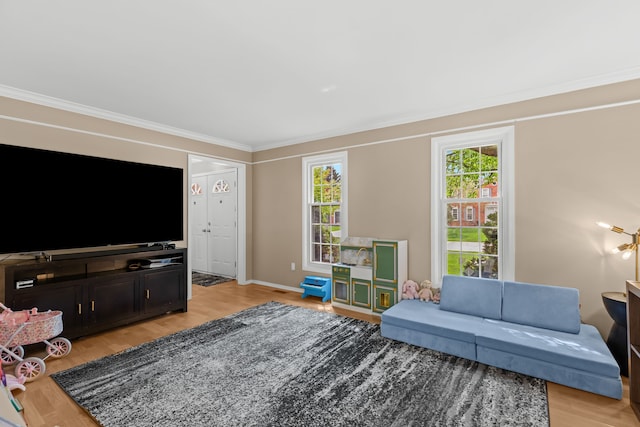 living room with baseboards, light wood-style floors, and crown molding