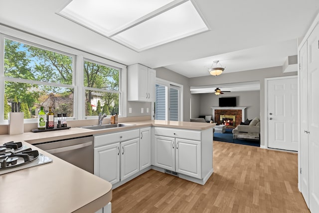 kitchen featuring a sink, light countertops, and light wood-style floors